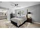 Comfortable bedroom with a ceiling fan, natural light, and an attached bathroom at 7708 Falcon Rest Cir, Raleigh, NC 27615