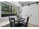 Charming breakfast nook with a large window and a view of the outdoors, adjacent to sliding barn doors at 7708 Falcon Rest Cir, Raleigh, NC 27615