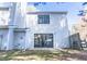 A two-story house featuring sliding glass doors, a window, and light gray siding, nestled in a well-maintained yard at 7708 Falcon Rest Cir, Raleigh, NC 27615