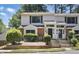 Inviting two-story townhome featuring a brick facade and well-maintained landscaping at 7708 Falcon Rest Cir, Raleigh, NC 27615