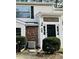 Inviting front entrance of a two-story home featuring a black door and brick accents at 7708 Falcon Rest Cir, Raleigh, NC 27615