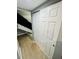 Hallway to stairs with closet and neutral colored walls and flooring at 7708 Falcon Rest Cir, Raleigh, NC 27615
