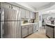 Well-lit kitchen showcasing stainless steel appliances and gray cabinetry at 7708 Falcon Rest Cir, Raleigh, NC 27615