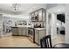 Stylish kitchen with stainless steel appliances and an open view into the dining and living areas at 7708 Falcon Rest Cir, Raleigh, NC 27615