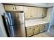 Spacious kitchen with stainless refrigerator, tile backsplash, light wood floors, and cabinets at 7708 Falcon Rest Cir, Raleigh, NC 27615