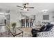 Open-concept living room featuring bar seating, modern décor, and a ceiling fan at 7708 Falcon Rest Cir, Raleigh, NC 27615