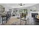 Open-concept living room flowing into a dining area, with a fireplace and lots of natural light at 7708 Falcon Rest Cir, Raleigh, NC 27615