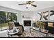 Cozy living room features a fireplace, a large window, and neutral tones at 7708 Falcon Rest Cir, Raleigh, NC 27615