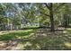 Community playground surrounded by mature trees with swings and climbing structures at 7708 Falcon Rest Cir, Raleigh, NC 27615