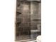 Stylish shower with modern black and marble tiling and a glass door at 7708 Falcon Rest Cir, Raleigh, NC 27615