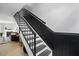 Modern staircase with black rails and white risers, leading to the upper level at 7708 Falcon Rest Cir, Raleigh, NC 27615