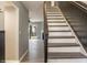 Elegant staircase with white risers and wood treads, leading to the upper level at 7708 Falcon Rest Cir, Raleigh, NC 27615