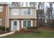 Charming townhouse with brick and beige siding, complemented by white window shutters and a well-maintained lawn at 7746 Kingsberry Ct, Raleigh, NC 27615