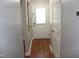 Well-lit hallway features hardwood floors and neutral paint, leading to a bright front door at 7746 Kingsberry Ct, Raleigh, NC 27615