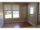 Bright living area with large windows, hardwood floors, and neutral paint at 7746 Kingsberry Ct, Raleigh, NC 27615