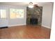 Spacious living room with a stone fireplace, ceiling fan and a large window at 7746 Kingsberry Ct, Raleigh, NC 27615