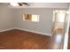 Open living room with hardwood floors, view to the kitchen, and access to entryway at 7746 Kingsberry Ct, Raleigh, NC 27615