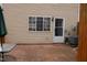 Outdoor patio area with brick pavers, access door to the home, and a table with umbrella at 7746 Kingsberry Ct, Raleigh, NC 27615
