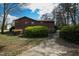 House with lush shrubbery and driveway, showing brick foundation at 817 Glen Eden Dr, Raleigh, NC 27612