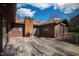 Wooden deck overlooking the lush backyard, with barbecue grill and brick chimney at 817 Glen Eden Dr, Raleigh, NC 27612