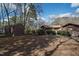 Backyard featuring a wooden shed, trees, lawn, and side of house at 817 Glen Eden Dr, Raleigh, NC 27612