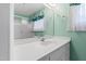Bathroom with seafoam-green walls, a white vanity, and a glass door shower stall at 817 Glen Eden Dr, Raleigh, NC 27612