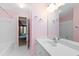 Bright bathroom featuring a white vanity, large mirror, and white tile floors and walls at 817 Glen Eden Dr, Raleigh, NC 27612