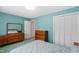 This bedroom boasts bright, turquoise walls, ample storage space and soft green carpet at 817 Glen Eden Dr, Raleigh, NC 27612