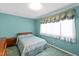 Comfortable bedroom with blue walls, soft carpet, and natural light at 817 Glen Eden Dr, Raleigh, NC 27612