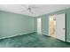 Bedroom with seafoam-green walls and carpet as well as a ceiling fan at 817 Glen Eden Dr, Raleigh, NC 27612