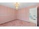 Inviting dining room with a chandelier, plush carpet, and convenient access to the kitchen at 817 Glen Eden Dr, Raleigh, NC 27612