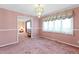 Elegant dining room featuring a chandelier, plush carpet, and an inviting atmosphere for entertaining at 817 Glen Eden Dr, Raleigh, NC 27612
