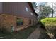 Brick and brown siding exterior view of home with walkway and mature trees, complemented by green landscaping at 817 Glen Eden Dr, Raleigh, NC 27612