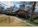 Well-maintained front yard with a lush lawn, mature trees, and landscaping surrounding a charming home at 817 Glen Eden Dr, Raleigh, NC 27612