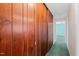 Hallway with a built in wooden storage cabinet on one wall and a light green carpet at 817 Glen Eden Dr, Raleigh, NC 27612