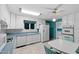 Charming kitchen features turquoise countertops, white cabinets, and stainless steel appliances at 817 Glen Eden Dr, Raleigh, NC 27612