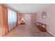 Bright living room featuring plush carpet, soft curtains, and lots of natural light at 817 Glen Eden Dr, Raleigh, NC 27612