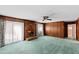 Cozy living room with brick fireplace, wood paneled walls, and abundant natural light at 817 Glen Eden Dr, Raleigh, NC 27612