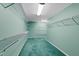 Empty walk-in closet with seafoam-green walls and metal racks for storage at 817 Glen Eden Dr, Raleigh, NC 27612