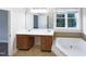 Bright bathroom featuring double vanity, soaking tub and window offering natural light at 9100 Palm Bay Cir, Raleigh, NC 27617