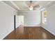 Spacious bedroom featuring a tray ceiling and gleaming hardwood floors, creating an inviting and elegant retreat at 9100 Palm Bay Cir, Raleigh, NC 27617