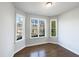 Bright bedroom with three large windows and hardwood floors at 9100 Palm Bay Cir, Raleigh, NC 27617