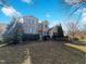 Beautiful brick home features manicured landscaping, a front yard and a sunny blue sky at 9100 Palm Bay Cir, Raleigh, NC 27617