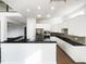 Well-lit kitchen boasts white cabinets, stainless steel appliances, and a breakfast bar, perfect for modern living at 9100 Palm Bay Cir, Raleigh, NC 27617