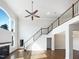 Spacious living room featuring high ceilings, a cozy fireplace, and a grand staircase, creating a welcoming ambiance at 9100 Palm Bay Cir, Raleigh, NC 27617