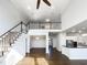 Expansive living area featuring a loft, staircase, and open-concept design, perfect for modern living and entertaining at 9100 Palm Bay Cir, Raleigh, NC 27617