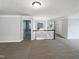 Open loft area with neutral carpet, chandelier, railing, and access to rooms at 9100 Palm Bay Cir, Raleigh, NC 27617