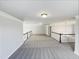 Spacious loft area with neutral carpeting, ample lighting, and view to the main level at 9100 Palm Bay Cir, Raleigh, NC 27617