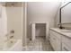 Well-lit bathroom featuring a shower, tile floors, double sink vanity, and closet at 102 Ventura Woods Ct, Wake Forest, NC 27587