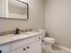 Bright bathroom featuring white vanity with granite countertop and modern black faucet and mirror at 102 Ventura Woods Ct, Wake Forest, NC 27587